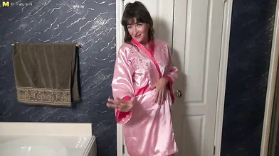 Cute American housewife getting wet in the bathtub